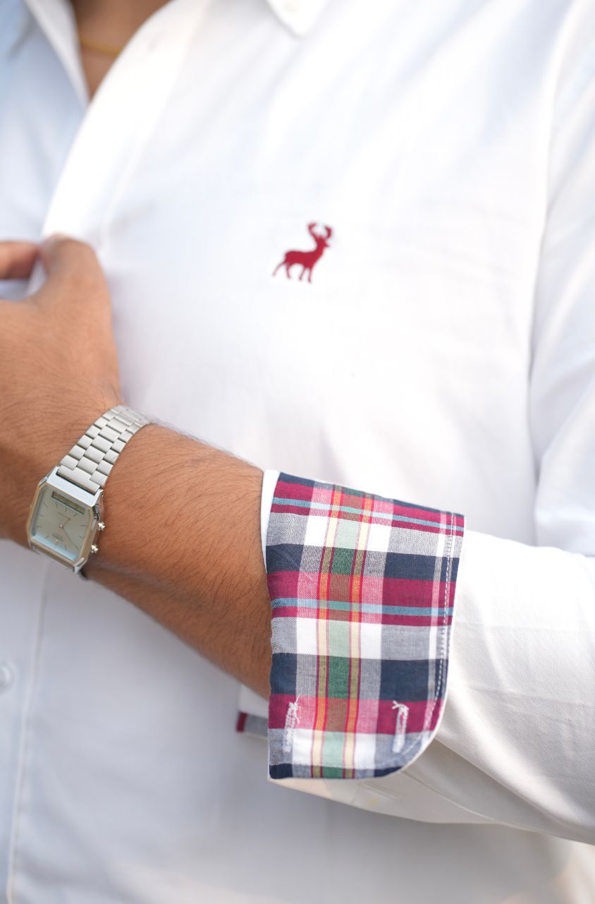 White shirt with plaid cuff and silver watch on wrist